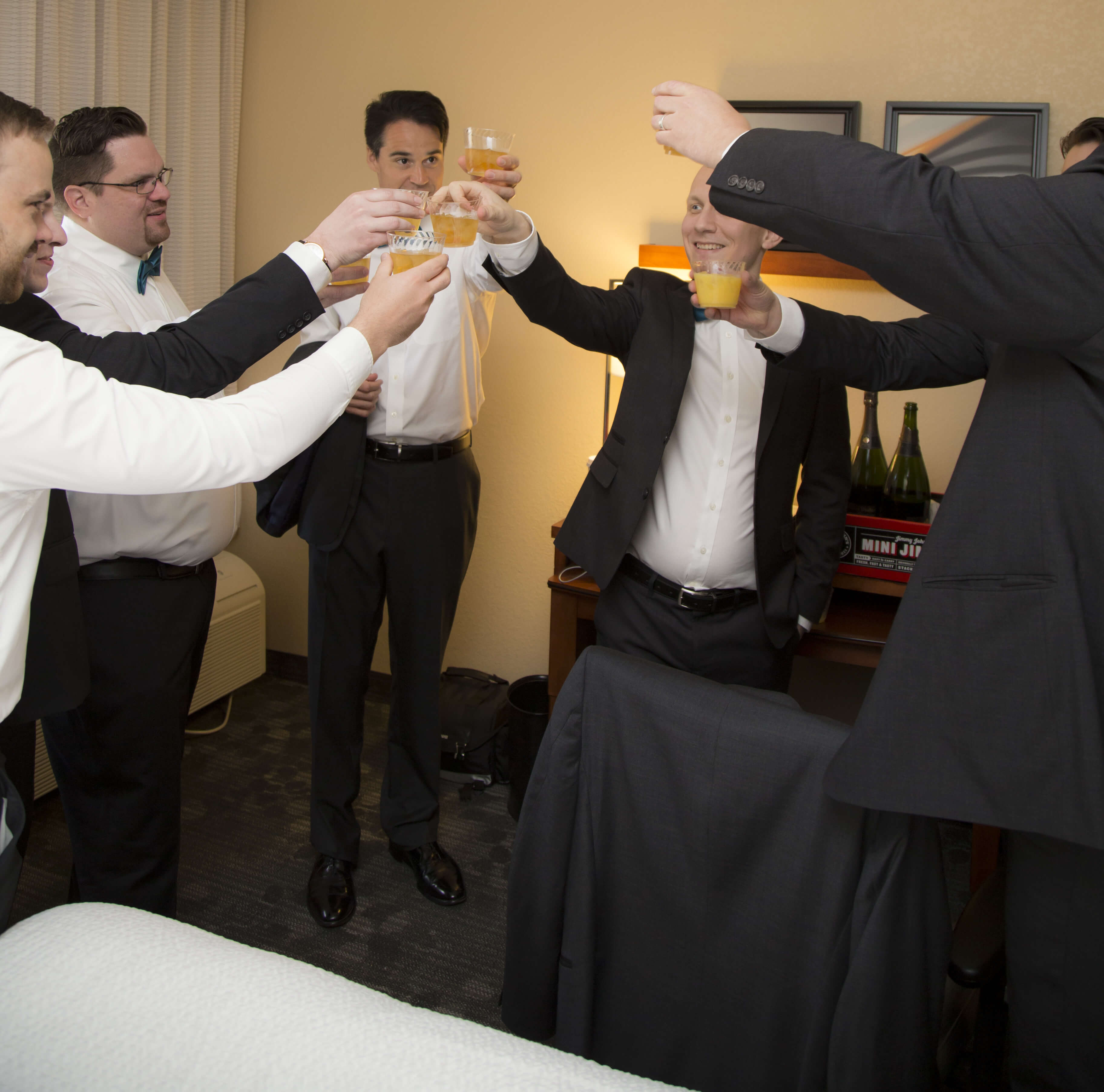 the groom and best men drinking and cheering