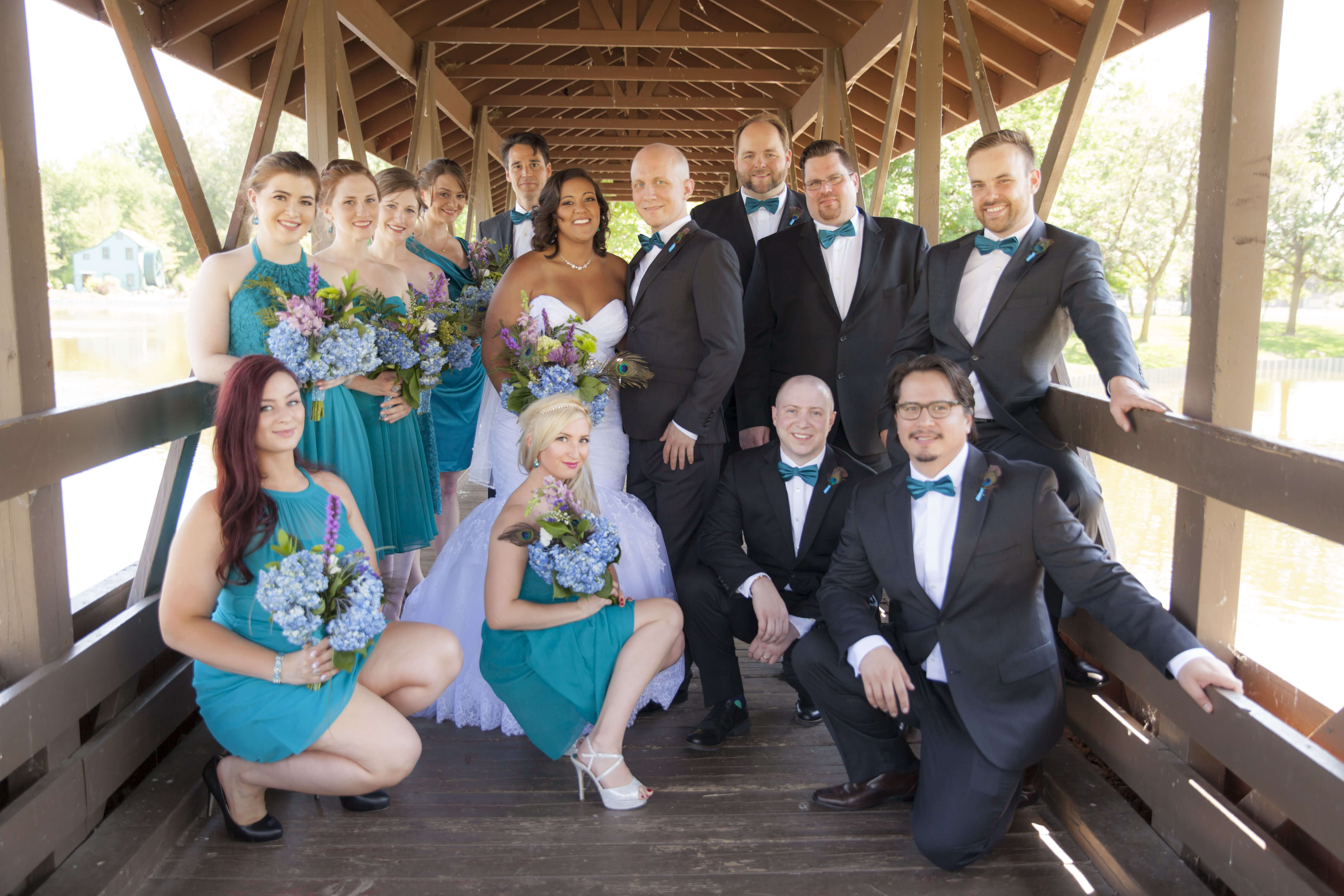 the bridal party posing on a bridge