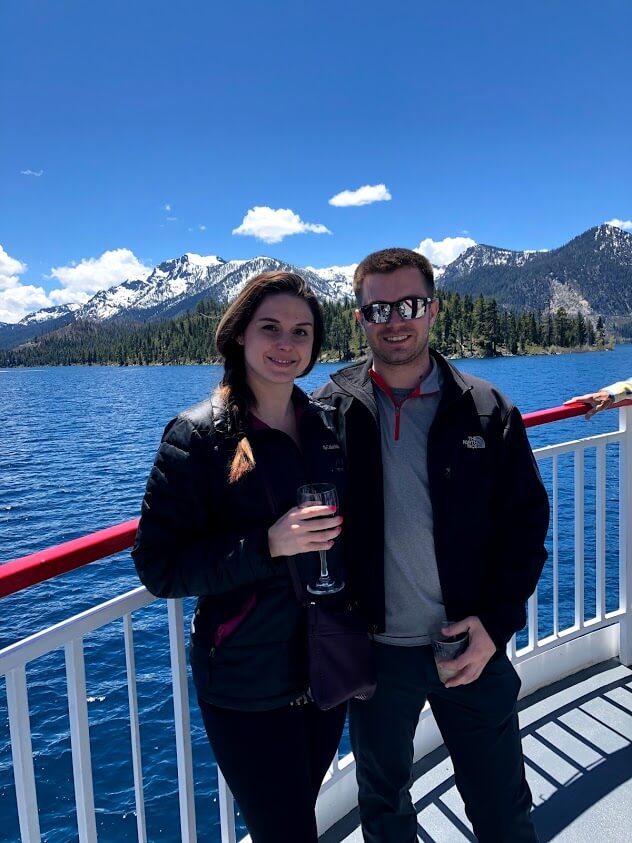 Angela and Maciej standing together in front of mountains.