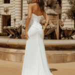 back of sleeveless, elegant wedding dress, Collins, with a high thigh slit and long train