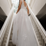 Bride going up the stairs looking back, wearing a beautiful lace and chiffon wedding dress, Maryam