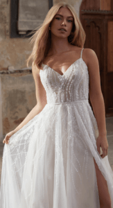Blond woman in wedding dress with thigh-high slit and beaded lace
